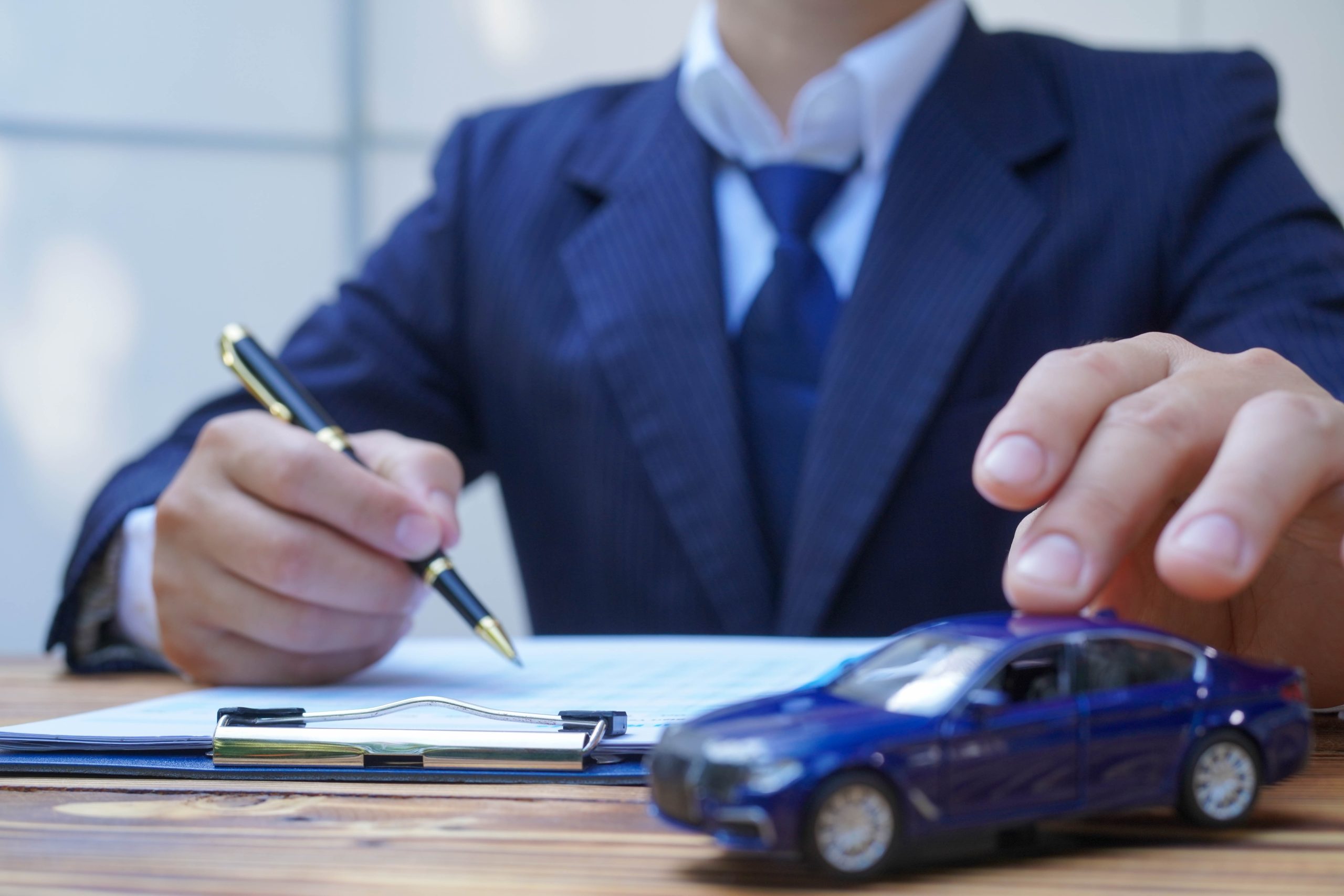 Businessperson signing car finance documents